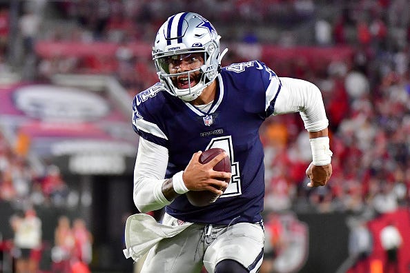 Dak Prescott scrambles to pick up yards in a Cowboys game.