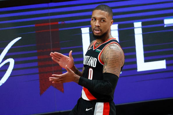 Damian Lillard claps his hands during a Trail Blazers game