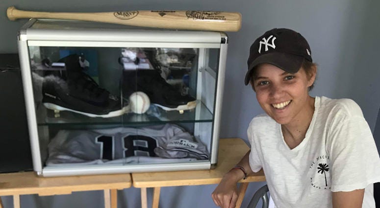 Danielle DeSimone poses with her Didi Gregorius keepsakes.