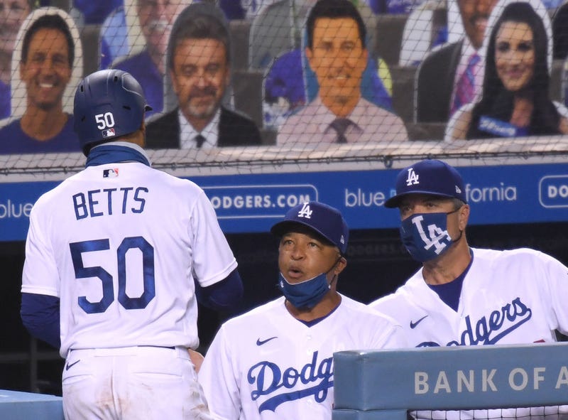 Dave Roberts celebrates with Mookie Betts.