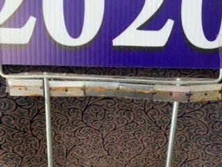 razor blades sewn into a trump-Pence sign