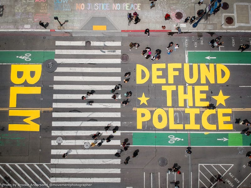 An overhead look at a "Defund The Police" mural in front of San Francisco City Hall.