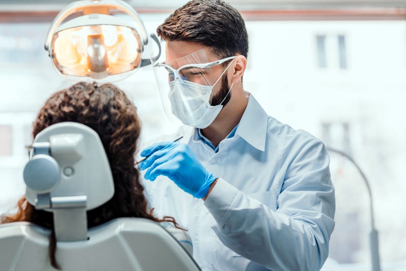 Dentist treats patient