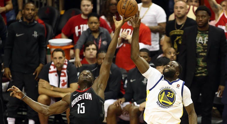 The Rockets' Clint Capela (15) plays for the ball against the Warriors' Draymond Green (23) during Game 2 of the Western Conference finals on May 16, 2018, at the Toyota Center in Houston.