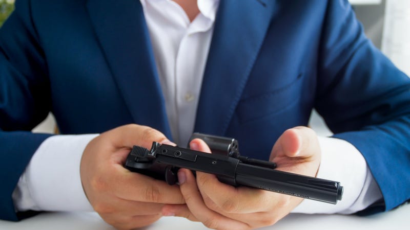 Man Loading Gun At Workplace