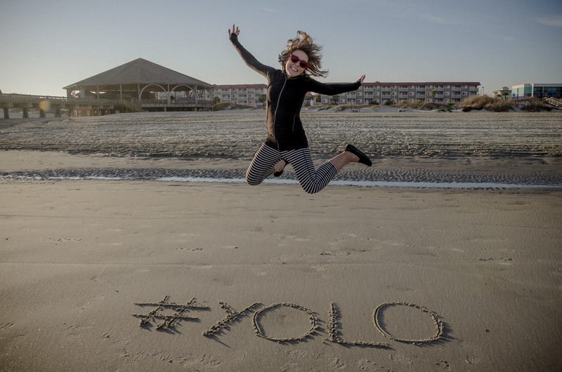 YOLO girl jumping on beach