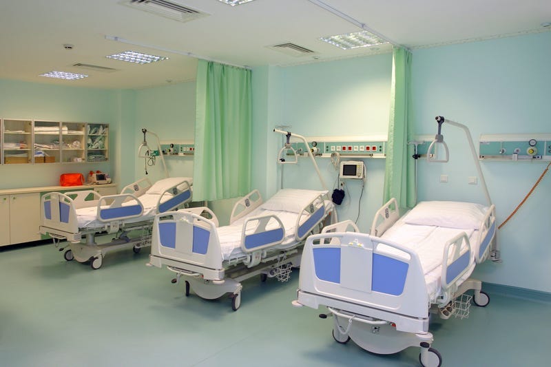 A modern hospital saloon with beds.