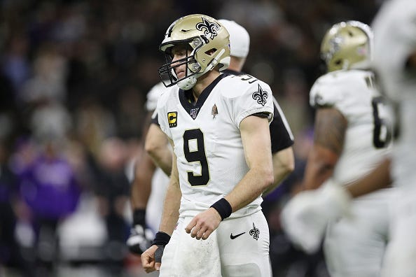 Drew Brees walks off the field after a fumble.