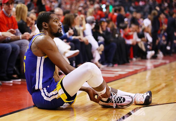 Kevin Durant grabs his ruptured Achilles tendon in the 2019 NBA Finals.