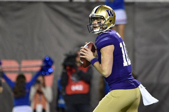 Jacob Eason eyes his receivers down field with Washington.