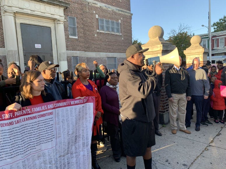 Activist Antoine Little leads a rally this morning outside T.M. Pierce Elementary School.