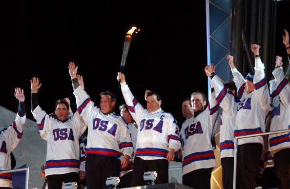 Mike Eruzione and the 1980 U.S. Hockey Team light the torch at the 2002 Winter Games.