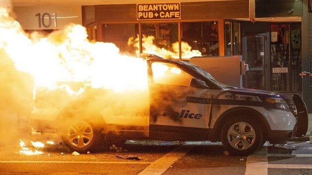 A Boston Police Department cruiser burns after being set on fire during May 31 demonstrations in Boston.