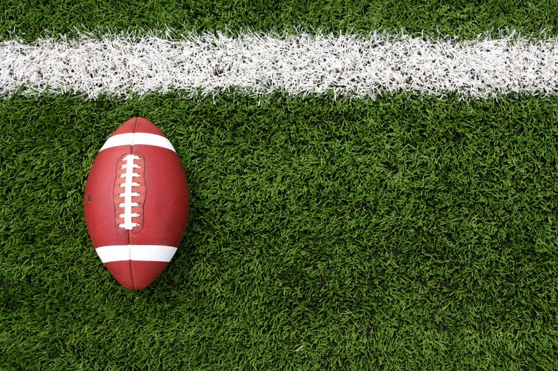 Overhead view of a football lying on a football field