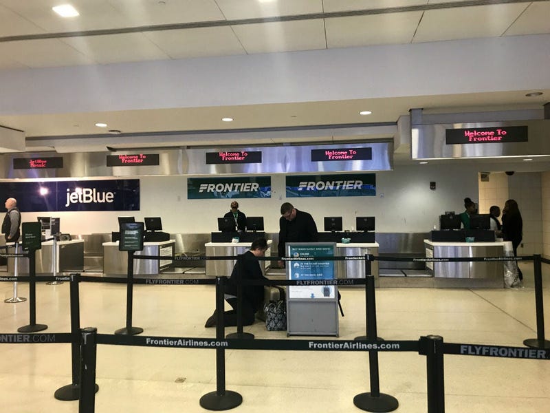 The Frontier Airlines check-in counter is shown at Philadelphia International Airport.