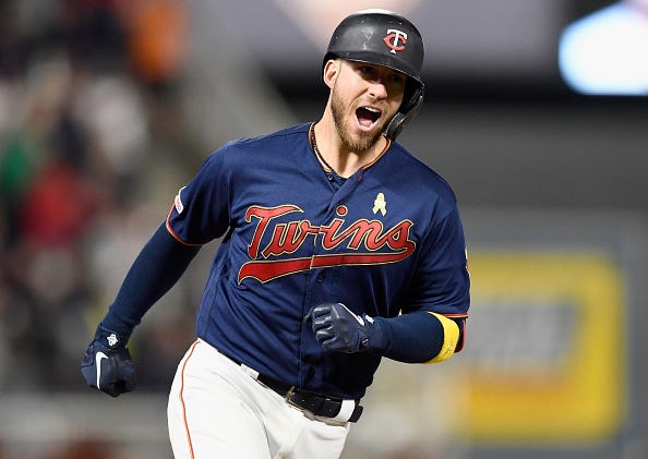 Twins' Mitch Garver celebrates a home run as he rounds the bases.