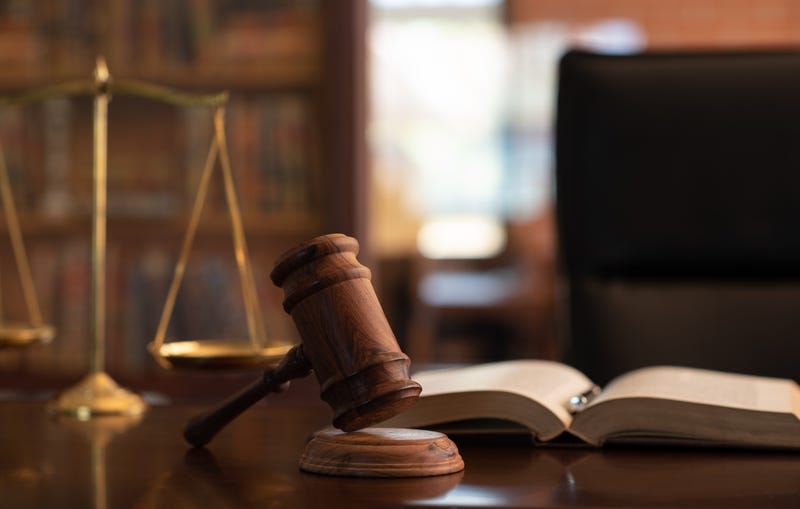 judge gavel, law books and scales of justice on desk
