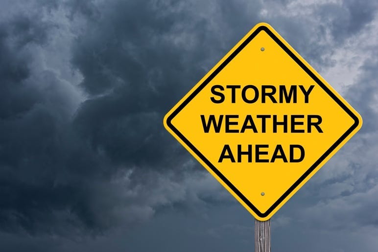 Stormy Weather Ahead Caution Sign With Storm Cloud Background