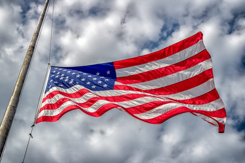 American flag at half-staff blowing in wind