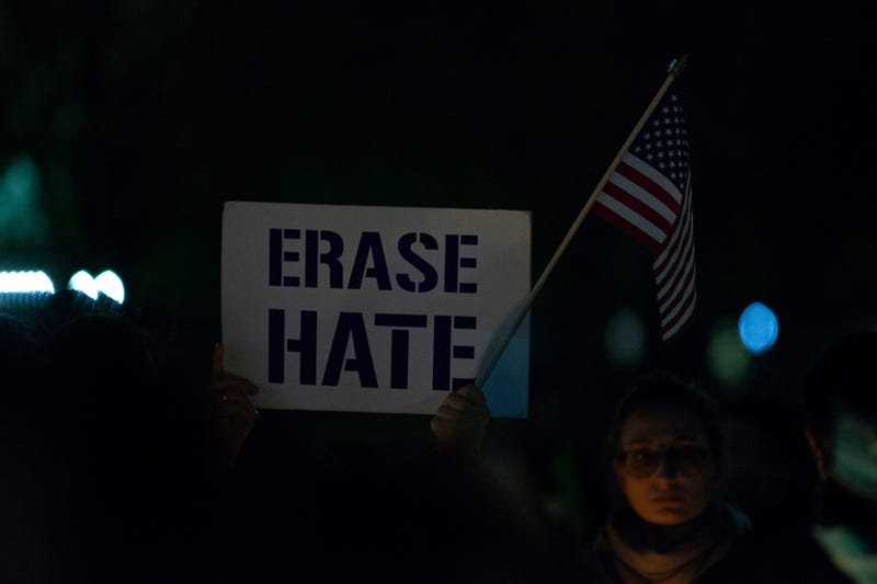 WASHINGTON, DC - OCTOBER 27: A vigil participant holds a 'Erase Hate' sign during a Havdalah vigil for the victims of the Tree of Life Congregation shooting in front of the White House on October 27, 2018 in Washington, DC.