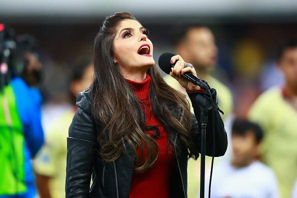 Singer Ana Barbara sings the national anthem of Mexico during the final first leg match between America and Cruz Azul as part of the Torneo Apertura 2018 Liga MX at Azteca Stadium on December 13, 2018 in Mexico City, Mexico.