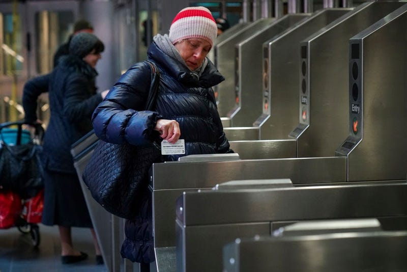 A customer swipes her metro card