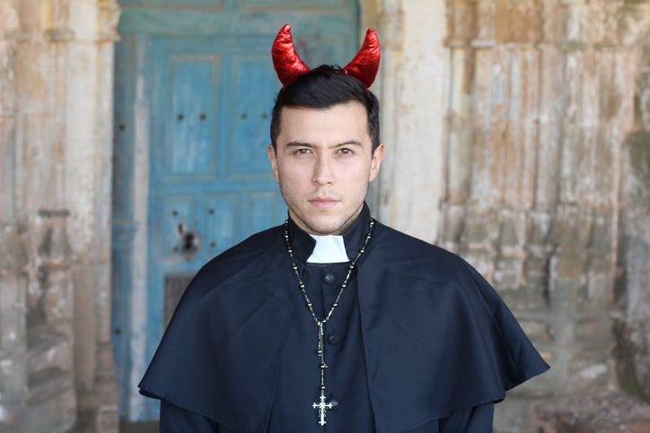 Evil looking priest with horns.