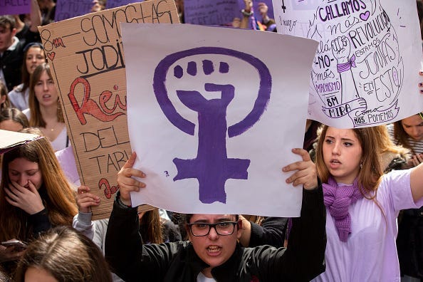 MARCH 08: A student holds a placard with feminist symbol during protest along the streets during the International Women's Day on March 08, 2019 in Madrid, Spain. Spain celebrates International Women's Day today with a women's general strike and countless