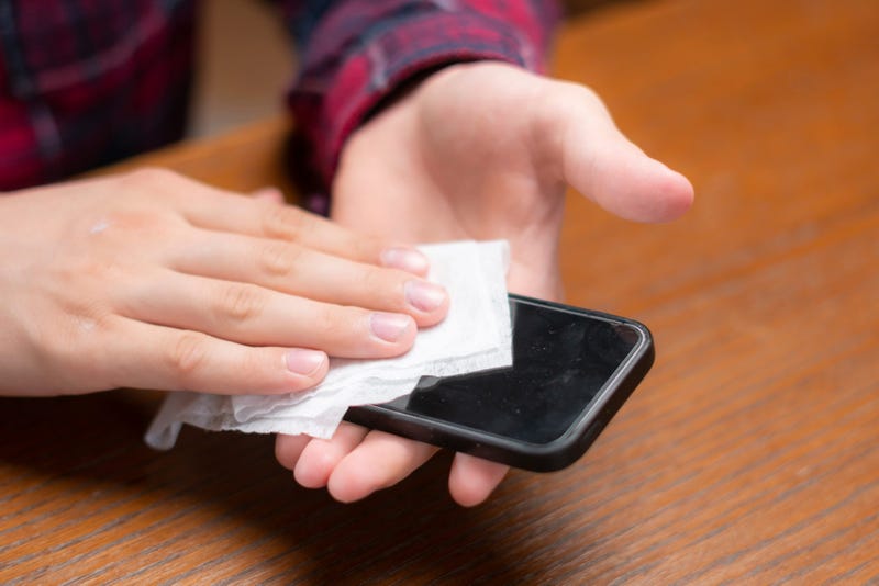 Person cleans cell phone