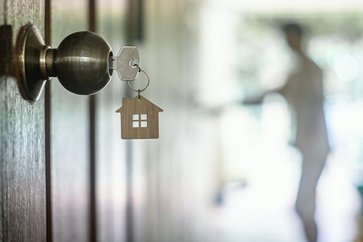 House key with home keyring in keyhole