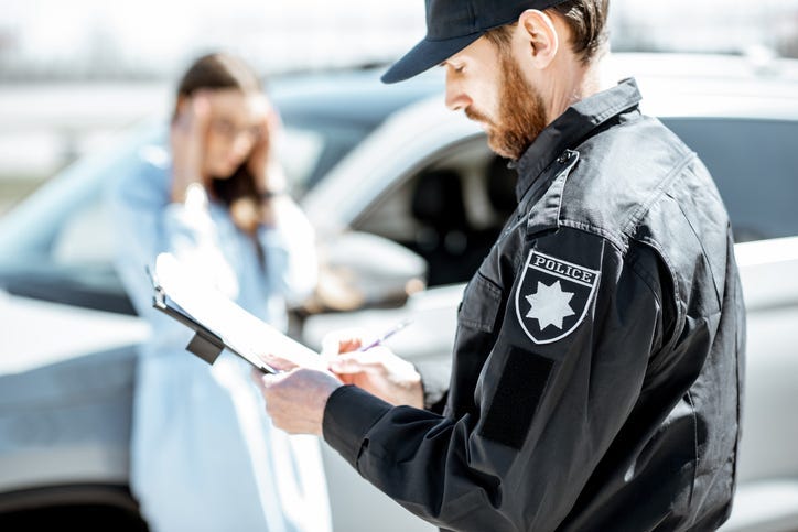 Police issuing a ticket to a woman