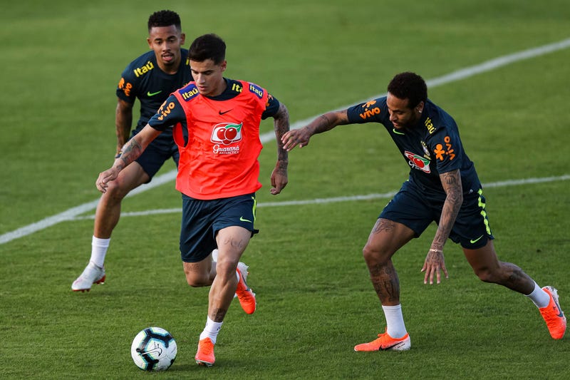 Philippe Coutinho (C) and Neymar Jr (R) compete for the ball during a training session of the Brazilian national football team at the squad's Granja Comary training complex on May 28, 2019 in Teresopolis, Brazil.