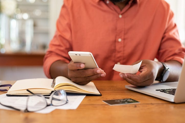 Man Depositing Check With Mobile Phone