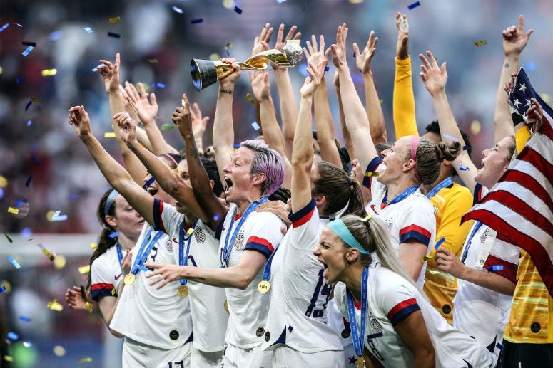 Megan Rapinoe of the USA lifts the FIFA Women's World Cup Trophy following her team's victory in the 2019 FIFA Women's World Cup France Final match between The United States of America and The Netherlands at Stade de Lyon on July 07, 2019 in Lyon, France.