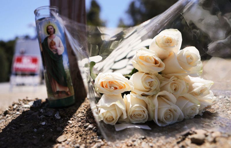 GILROY, CALIFORNIA - JULY 29: Flowers and a candle sit outside the site of the Gilroy Garlic Festival after a mass shooting there yesterday on July 29, 2019 in Gilroy, California. Three victims were killed and at least a dozen were wounded before police o