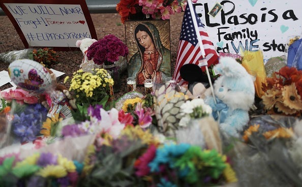 Flowers and mementos are seen at a makeshift memorial outside Walmart, near the scene of a mass shooting which left at least 20 people dead, on August 4, 2019 in El Paso, Texas. A 21-year-old male suspect was taken into custody in the city which sits alon
