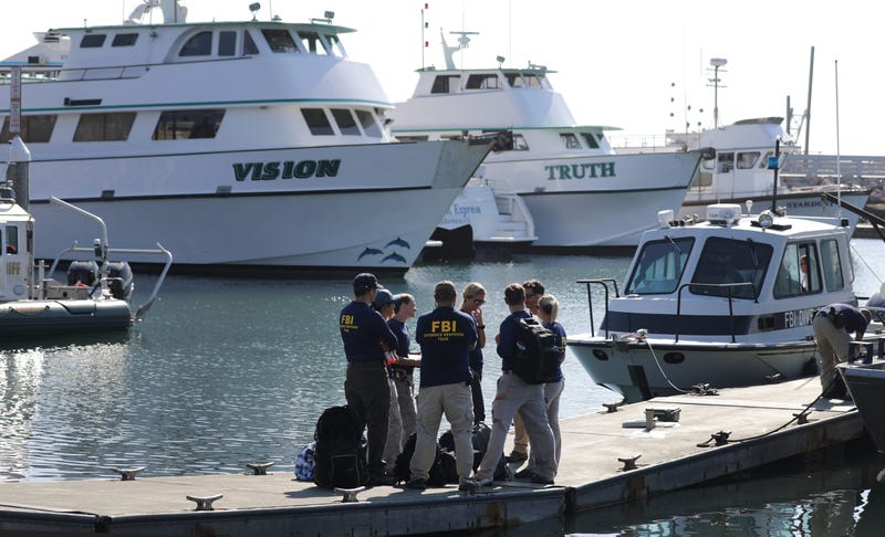 FBI personnel stand on a jetty in front of the ships Vision (L) and Truth, sister vessels of the diving ship Conception, in Santa Barbara Harbor on September 4, 2019 in Santa Barbara, California.