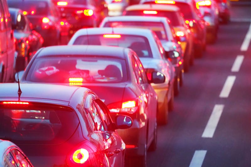 Evening, city traffic jams, street road. Standing in a row cars, rear view, red stop lights.