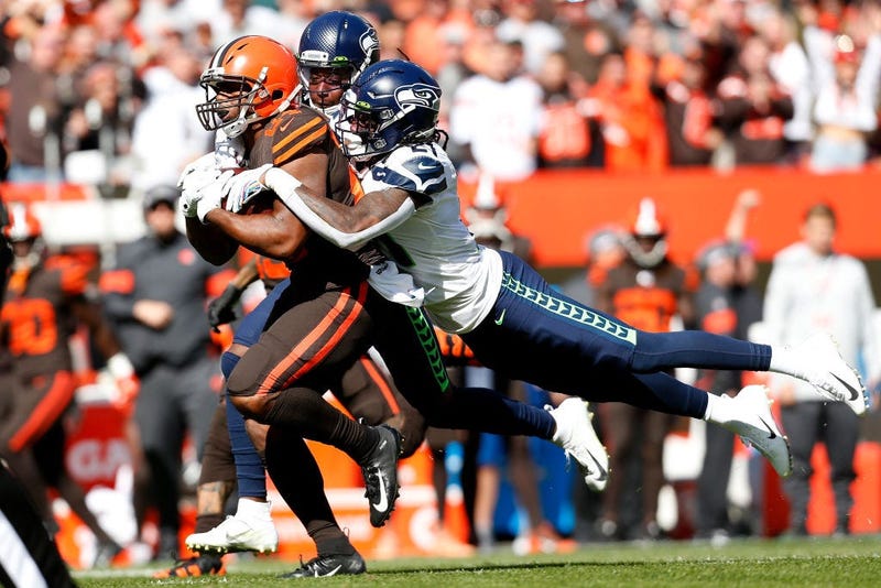 CLEVELAND, OH - OCTOBER 13: Shaquill Griffin #26 of the Seattle Seahawks and Tre Flowers #21 combine to tackle Nick Chubb #24 of the Cleveland Browns during the first quarter at FirstEnergy Stadium on October 13, 2019 in Cleveland, Ohio. (Photo by Kirk Ir