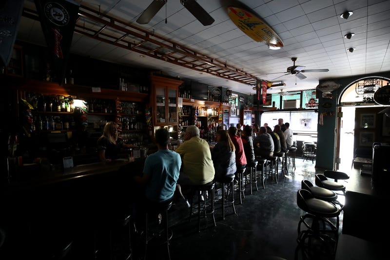 athy Sanchez bartends at The Town Square bar where the lights are out on October 10, 2019 in Sonoma, California.