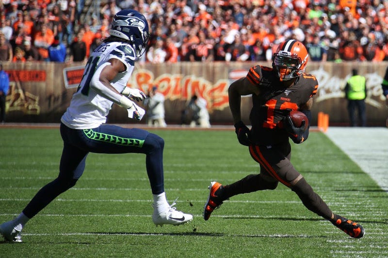 CLEVELAND, OHIO - OCTOBER 13: Odell Beckham #13 of the Cleveland Browns looks for yards after a first quarter catch next to Tre Flowers #21 of the Seattle Seahawks at FirstEnergy Stadium on October 13, 2019 in Cleveland, Ohio. (Photo by Gregory Shamus/Get