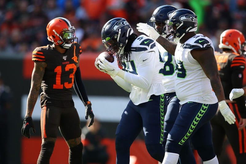 CLEVELAND, OHIO - OCTOBER 13: Ezekiel Ansah #94 of the Seattle Seahawks celebrates his third quarter fumble recovery with teammates in front of Odell Beckham #13 of the Cleveland Browns at FirstEnergy Stadium on October 13, 2019 in Cleveland, Ohio. (Photo