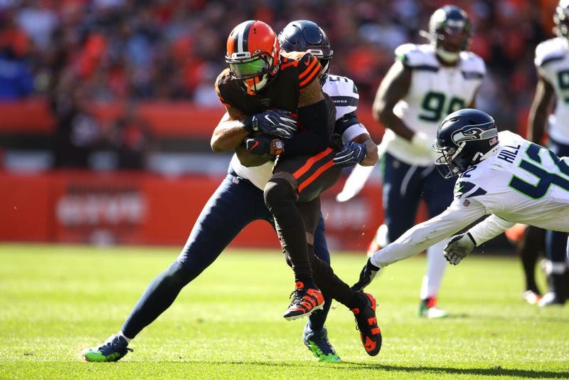 CLEVELAND, OHIO - OCTOBER 13: Odell Beckham #13 of the Cleveland Browns is tackled by K.J. Wright #50 of the Seattle Seahawks and Lano Hill #42 after a third quarter catch at FirstEnergy Stadium on October 13, 2019 in Cleveland, Ohio. (Photo by Gregory Sh