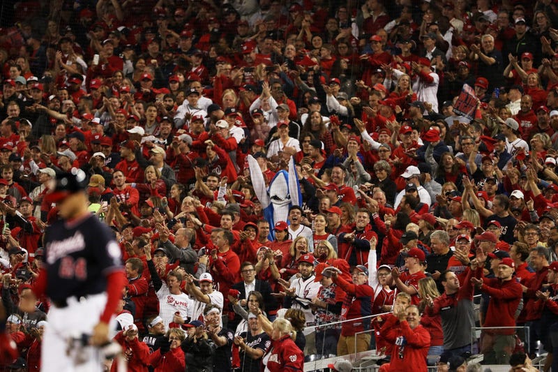 A fan dressed as a shark cheers as Gerardo Parra in the NLCS.