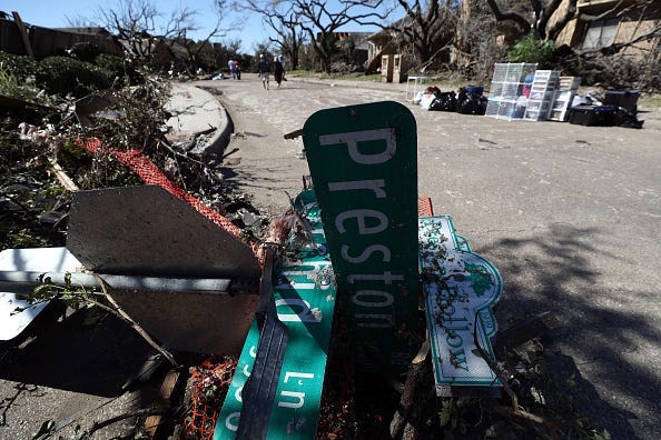 A fallen street sign in the Preston Hollow neighborhood on October 21, 2019 in Dallas, Texas. A tornado struck Sunday night causing major damage to homes, businesses and schools but no deaths or serious injuries have been reported.