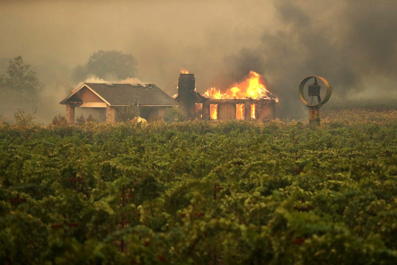 4: A home burns near a vineyard after the Kincade Fire burned through the area on October 24, 2019 in Geyserville, California.