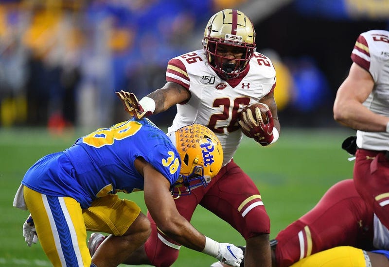 PITTSBURGH, PA - NOVEMBER 30: David Bailey #26 of the Boston College Eagles carries the ball in front of Cam Bright #38 of the Pittsburgh Panthers in the first quarter at Heinz Field on November 30, 2019 in Pittsburgh, Pennsylvania.