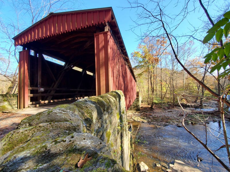 This covered bridge is located along forbidden drive and crosses Wissahickon Creek in the Wissahickon Valley Park in Philadelphia Pennsylvania.