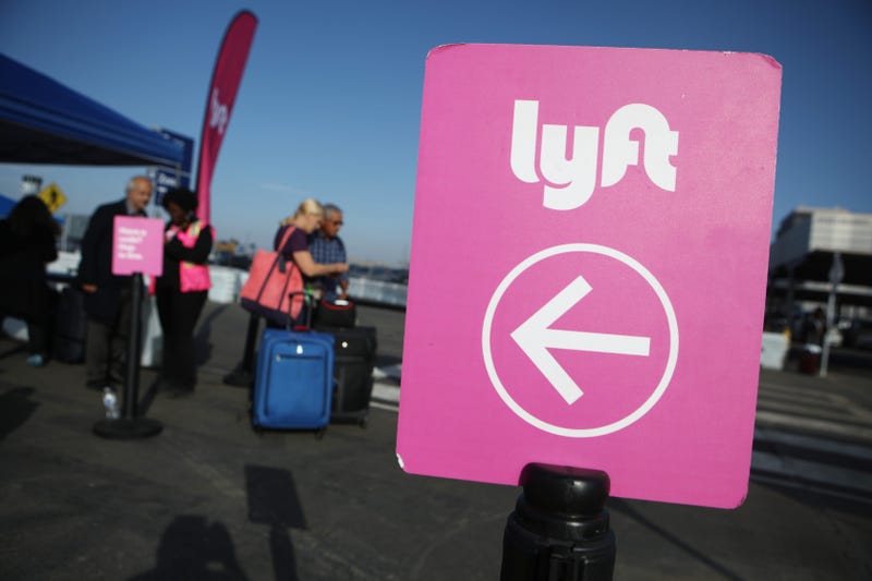 Arriving passengers wait to board Lyft vehicles at the new 'LAX-it' ride-hail passenger pickup lot at Los Angeles International Airport (LAX) on November 6, 2019.