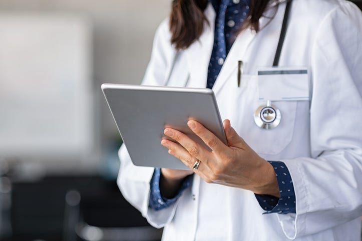A doctor using a tablet